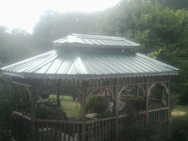 Two tier green metal roof on a garden gazebo in Towanda